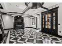Striking living room boasts a black and white checkered floor and decorative ceiling at 318 W Lillington St, Angier, NC 27501