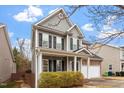Attractive two-story home with covered front porch, light gray siding, and well-maintained landscaping at 4909 Jelynn St, Raleigh, NC 27616