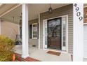 Inviting front porch showcasing a swing, sidelights, and decorative door with house number at 4909 Jelynn St, Raleigh, NC 27616