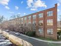 Exterior of a brick building with large windows under a blue sky at 500 N Duke St # 55-103, Durham, NC 27701