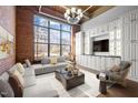 Bright living room featuring exposed brick, large windows, and custom built-ins at 500 N Duke St # 55-103, Durham, NC 27701