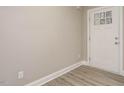 A bright foyer with gray wood-look flooring and a white painted door at 531 Perth Rd, Sanford, NC 27332