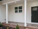 A charming covered front porch with brick and stamped concrete, and painted support columns at 531 Perth Rd, Sanford, NC 27332