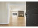 Inviting living room showcasing a brick fireplace, hardwood floors, and abundant natural light at 6065 Merion Cir, Sanford, NC 27332
