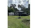 A single story home with a metal shed and an old truck in the front yard at 652 Old Sanford Rd, Moncure, NC 27559