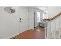 Warm foyer with brick flooring, with access to the living room and staircase at 100 Queensferry Rd, Cary, NC 27511