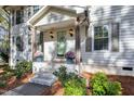 Inviting front entrance with potted flowers and a decorative wreath on the door at 100 Queensferry Rd, Cary, NC 27511