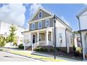 Stylish two-story home featuring a welcoming front porch, attractive siding, and well-maintained landscaping at 1005 Whistler St, Durham, NC 27713
