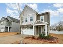 Two-story home featuring gray siding, stone accents and a covered entryway at 1016 Matterhorn Dr, Fuquay Varina, NC 27526