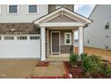 Covered front porch with stone accents and gray front door at 1016 Matterhorn Dr, Fuquay Varina, NC 27526
