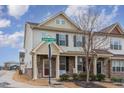 Charming townhome features a stone facade, inviting front porch, and well-manicured landscaping at 1018 Tranquil Creek Way, Wake Forest, NC 27587