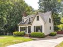 This home features an idyllic yard, driveway and a traditional design at 104 Pinecroft Dr, Raleigh, NC 27609