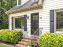 A beautiful front entrance with brick steps and manicured shrubbery at 104 Pinecroft Dr, Raleigh, NC 27609
