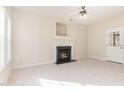 Bright living room featuring a fireplace, neutral carpeting, and natural light from the windows and glass door at 105 Caribbean Ct, Knightdale, NC 27545
