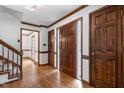 Inviting foyer with wood floors and trim, showcasing the home's paneled front door and interior doors at 112 Ridgepath Way, Cary, NC 27511