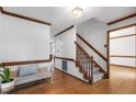 Bright foyer features hardwood floors, a staircase, and classic wood trim details, offering a warm welcome at 112 Ridgepath Way, Cary, NC 27511