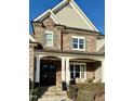 Charming front porch with stone accents, decorative columns, and cozy seating, perfect for relaxing outdoors at 113 Hardy Oaks Way, Holly Springs, NC 27540