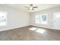 Bright living room with hardwood floors, large windows, and a ceiling fan at 132 Ambergate Ct, Rocky Mount, NC 27804