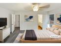 Bright staged bedroom featuring neutral walls, gray carpet, ceiling fan and lots of natural light at 1515 Indian Camp Rd, Chapel Hill, NC 27516