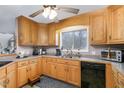 Charming kitchen with light wood cabinetry and sleek black appliances at 161 Kerr Lake Club Dr, Henderson, NC 27537