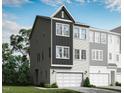 New three-story construction townhome with a single-car garage, and modern black and white siding on a sunny day at 2013 Trident Maple Ln, Chapel Hill, NC 27517