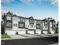 Row of new construction townhomes with garages, landscaped lawns, and modern gray and white color schemes at 2019 Trident Maple Ln, Chapel Hill, NC 27517