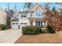 Well-maintained two-story home with a two-car garage and a cozy front porch, great for relaxation at 211 Court Jester Way, Morrisville, NC 27560