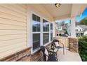 Cozy front porch featuring seating and stone accents, perfect for enjoying the outdoors at 211 Court Jester Way, Morrisville, NC 27560