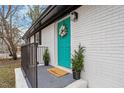 Inviting front entrance with a teal door, welcome mat, and potted plants at 2607 Nation Ave, Durham, NC 27707