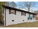 Charming home with a vibrant teal front door and fresh white brick exterior at 2607 Nation Ave, Durham, NC 27707