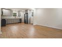 Open kitchen area boasting stainless steel appliances and streamlined gray cabinets at 2607 Nation Ave, Durham, NC 27707