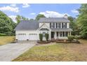 Inviting two-story home featuring a three-car garage, classic black shutters, and landscaped front yard at 270 S Ridge Dr, Garner, NC 27529