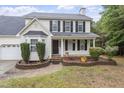Charming two-story home with a welcoming front porch, black shutters, and neat landscaping at 270 S Ridge Dr, Garner, NC 27529