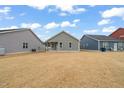 Expansive backyard with well-maintained lawn and view of neighboring homes under a bright blue, partly cloudy sky at 303 Bella Sq, Smithfield, NC 27577