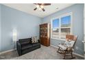 Comfortable sitting room with a ceiling fan, rocking chair, and plenty of natural light, creating a relaxing space at 303 Bella Sq, Smithfield, NC 27577
