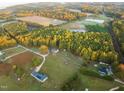 An aerial view of the property showing it's location in a rural area with mature tree coverage at 381 Reams Dr, Middlesex, NC 27557