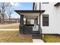 Close-up of the home's front porch featuring black brick pillars and sleek, modern railing at 405 N Hyde Park Ave, Durham, NC 27703