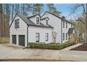 An alternate view of the house, showing the 2-car garage and trimmed evergreens in landscaping at 4436 Talcott Dr, Durham, NC 27705