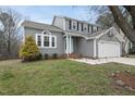 Charming gray two-story home with well-maintained lawn and a two-car garage at 5 Bonham Ct, Durham, NC 27703