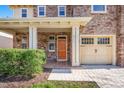 Charming home showcasing stone detailing, a covered porch, and manicured landscaping at 532 Front Ridge Dr, Cary, NC 27519
