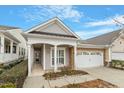 Beautiful home featuring a covered entryway, well-kept landscaping, and a two-car garage at 726 Finnbar Dr, Cary, NC 27519