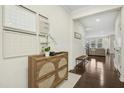 Inviting foyer with dark hardwood floors, stylish furnishings, and decorative wall art at 8004 Gilano Dr, Raleigh, NC 27603