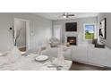 Bright living room with a fireplace, ceiling fan, and contemporary furniture at 15 Merle Dr, Wendell, NC 27591