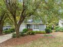 Charming gray home with lush landscaping, mature tree, and inviting curb appeal at 10 Marchmont Ct, Durham, NC 27705