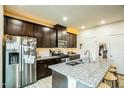 Modern kitchen features granite countertops, stainless steel appliances, and dark wood cabinetry at 1108 Orchard Stream Dr, Haw River, NC 27258