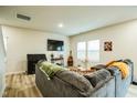 Bright and airy living room with large windows, cozy seating, and contemporary interior design at 1108 Orchard Stream Dr, Haw River, NC 27258
