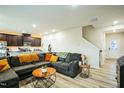 Open-concept living area with stylish sectional sofa, contemporary decor, and seamless kitchen access at 1108 Orchard Stream Dr, Haw River, NC 27258