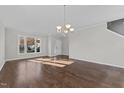 Spacious living room featuring wood floors, large windows, and modern lighting at 1510 Roaring Rapids Rd, Raleigh, NC 27610