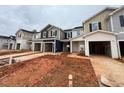 New townhome construction showing attached garages and exteriors that are under construction at 154 Parker Ln, Mebane, NC 27302