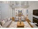 Bright living room boasting hardwood floors, a fireplace, and a soaring open staircase at 206 Collegiate Cir, Durham, NC 27713